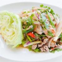 Larb Salad · Prepared with lime dressing, chili flakes, onions, parched rice powder, and mint leaves. Cho...