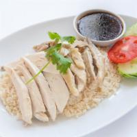 Kao Mun Kai Rice Plate · Steamed tender chicken on garlic and ginger rice, served with delicious ginger soy bean chil...