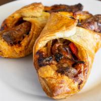 Sausage Roll · Seared bratwurst with a layer of gooey Cheddar cheese, tender peppers and onions, all held t...
