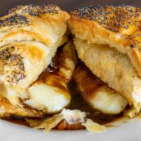 Brie en Croûte · A whole wheel of brie topped with a delightful apple compote, wrapped artfully in puff pastry.