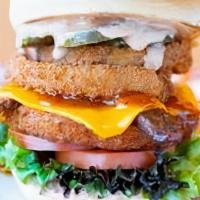 Maverick CluckWich · Breakin' Rules with a Crispy CluckPatty topped with Onion Rings, Organic Tempeh Bacon, Organ...