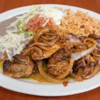 A. Pollo Adobado · Marinated chicken with tomatillo sauce served with rice and beans.