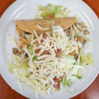 7A. Crispy Taco · Choice of meat, refried beans, lettuce, sour cream, guac, cheese, salsa