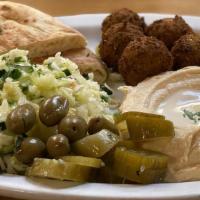 FALAFEL PLATE (V) · Combo plate with FALAFELS, Hummus, Israeli salad, Pickles, and Tahini sauce. Israeli salad h...