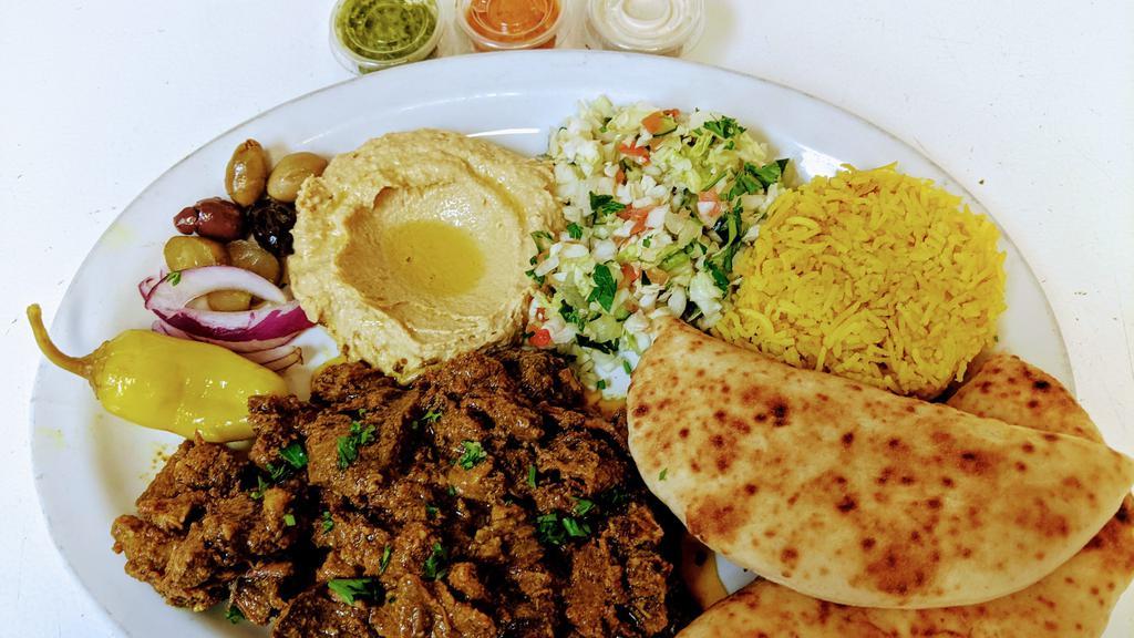 LAMB SHAWARMA PLATE · Lamb marinated in spices and served with Greek Salad and white Basmati rice. Greek salad has lettuce, tomatoes, cucumbers, red onions and Kalamata olives  with olive oil and lemon dressing.
