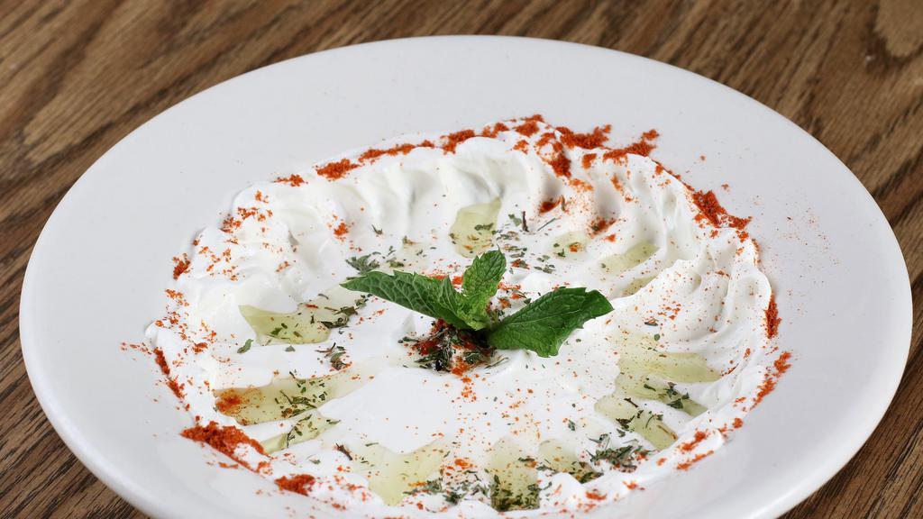 Labni · Syrian yogurt topped with dry mint and olive oil, served with pita.