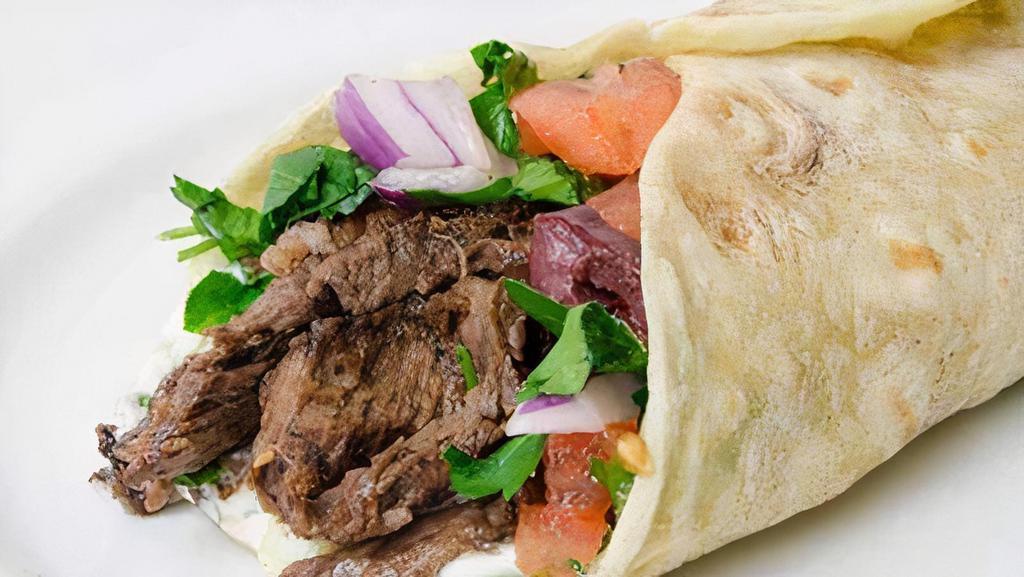 Beef Shawarma Wrap · Marinated beef pieces wrapped with lettuce, tomato, pickles and tahini sauce in pita bread.