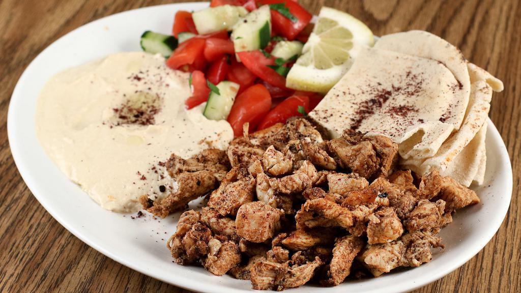 Chicken Shawarma Platter · Marinated pieces of grilled-cooked chicken served with hummus, cucumber salad, pita, garlic sauce and hot sauce.