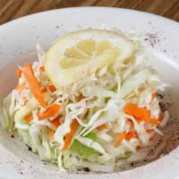 Cabbage Salad · Shredded cabbage mixed with Fiji apples, oil, vinegar and salt.
