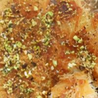 Kanafeh (1 Slice) · Soft cheese and shredded phyllo dough topped with pistachio pieces and syrup. Made in house.
