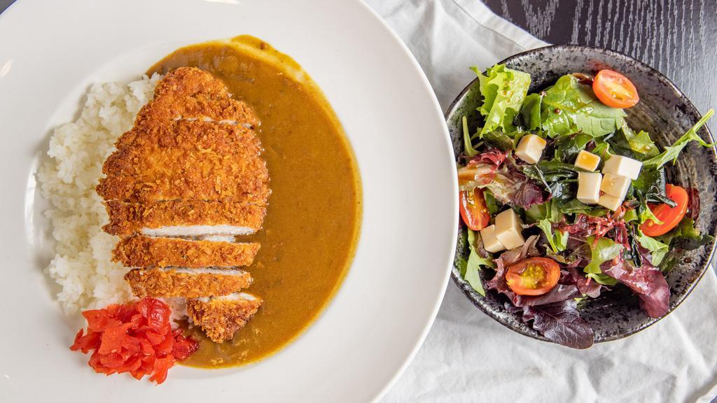 Katsu Curry · Beef based curry with pork cutlet, rice and a small salad