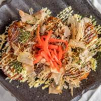 Takoyaki · Fried round pancakes with octopus inside topped with Japanese mayonnaise, okonomi sauce, bon...