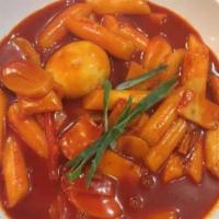 Spicy Rice Cakes (Tteokbokki) · Rice cakes in a spicy sauce with fish cakes, sausages, and green onion.
