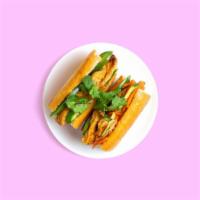 Tofu Egg Banh Mi · Marinated Tofu on a baguette with fried egg, spread, cucumber, and Jalapeño, topped with pic...