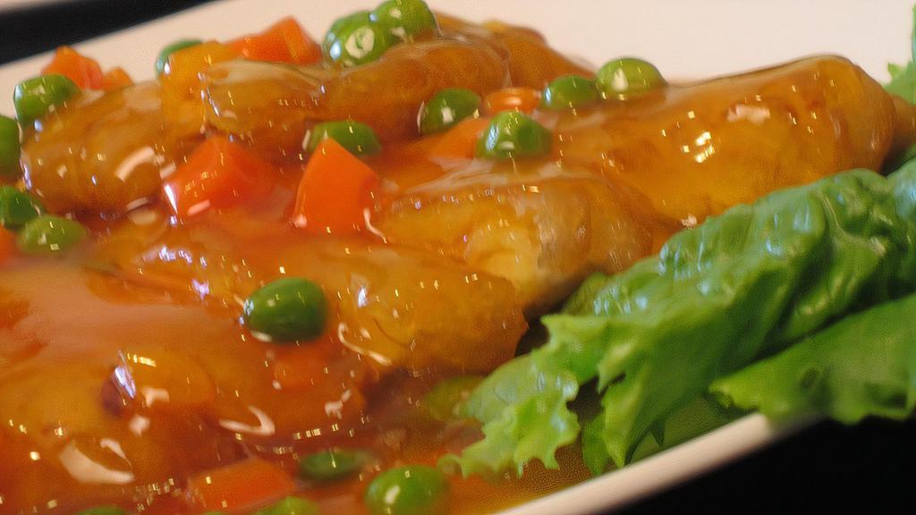 Lemon Chicken · Fried chicken breast fillets covered with tangy lemon sauce, peas & carrots.