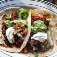 Carne Asada (Flour Tortilla) · Grilled steak, served in a flour tortilla taco topped with lettuce, guacamole, and pico de g...
