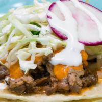 Carne Asada Taco · steak, chipotle salsa, onions, cabbage slaw, baja crema