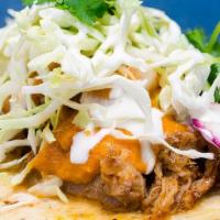 Carnitas Taco · slow braised pork, chipotle salsa, cabbage slaw, baja crema