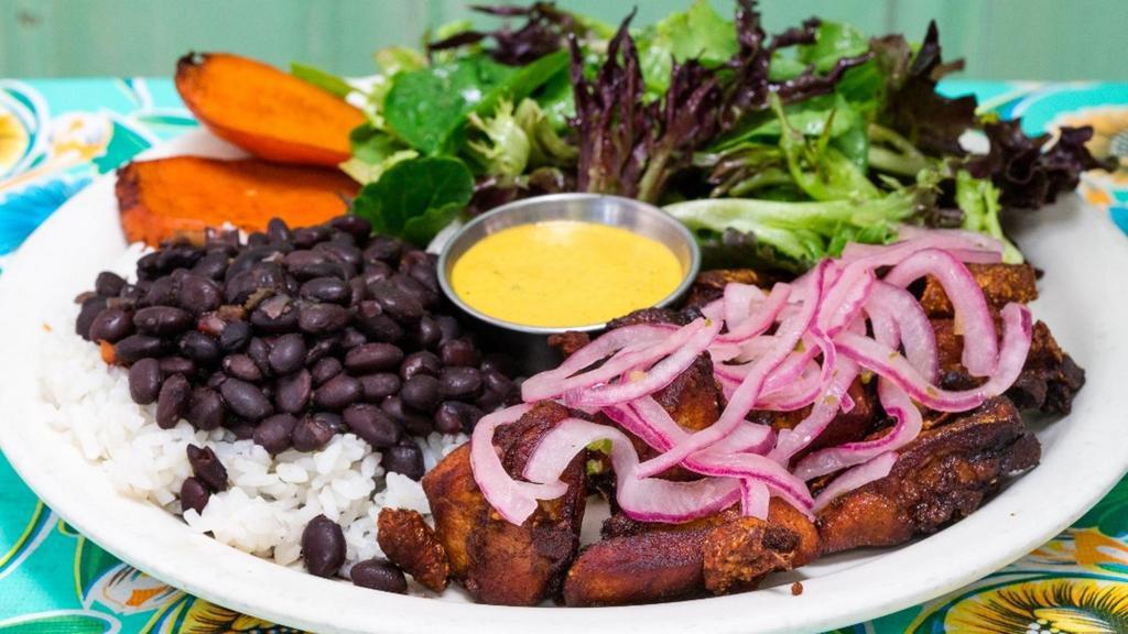 Chicharron Pollo · crispy pieces of free range chicken thighs topped with salsa criolla served with rice & pinto or black beans, organic salad and sweet potatoes