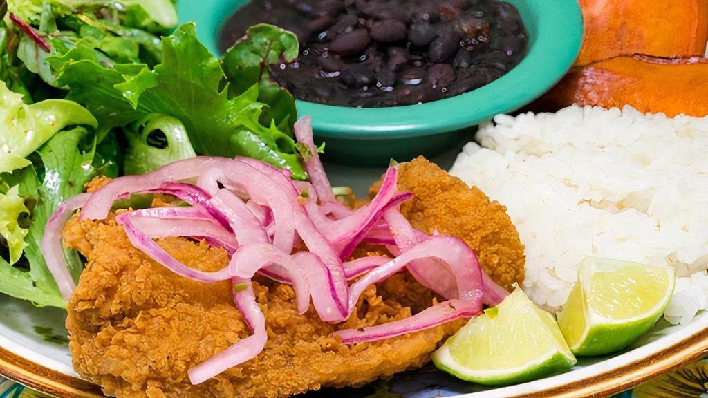 Pescado Frito · Fried fish topped with salsa criolla served with rice, pinto or black beans, organic salad and sweet potatoes
