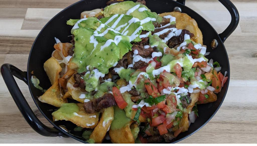 *Carne Asada Fries* · Your choice of meat, cheese, pico de gallo, sour cream, avocado and our famous avocado salsa piled on seasoned french fry potatoes