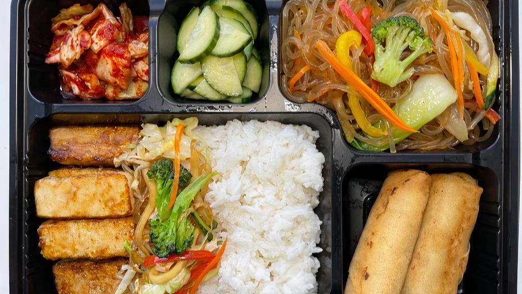 Tofu Box (Do-Si-Rack) · (Vegetarian) veggie spring rolls, japchae noodle (stir-fried vermicelli with vegetables), and two side dishes(pickled kimchi and pickled cucumber).