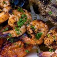 Shrimp Kabab Rice Plate · Shrimp kabab served with roasted tomato, seasoned onions, tahini, rice, hummus, salad and pi...