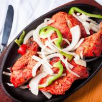26. Tandoori Chicken · Chicken marinated in yogurt, herbs and spices.