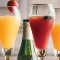 Sparkling Mimosa Flight · One champagne split and 3 different mixing flavors to try! Mango, White Peach and Triple ber...