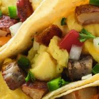 Farmhouse Tacos · Hickory-smoked bacon, sausage, scrambled eggs, roasted potatoes, cheddar cheese, jalapeno, t...