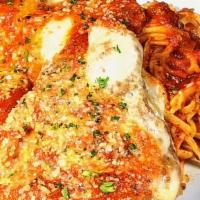 Chicken Parm. · Crispy hand breaded parmesan chicken breast with melted mozzarella and marinara sauce over l...
