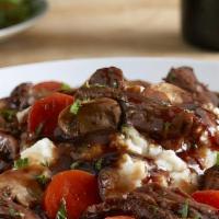 French Pot Roast · Slowly braised and simmered with carrots, celery and onions. Served on a bed of mashed potat...