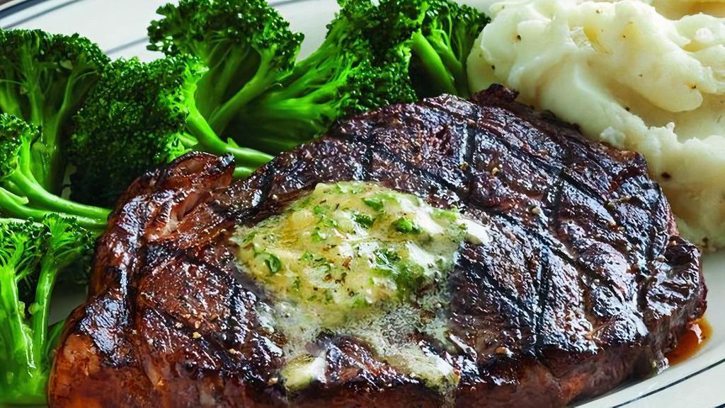 Ribeye Steak · 28-day aged, 10 oz. USDA choice ribeye steak. House-made herbes de Provence butter available upon request, your choice blackened or grilled. Served with choice of two sides. (890 cal) .