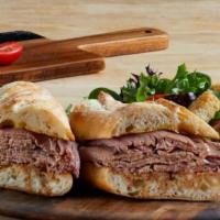 French Dip · Sliced roast beef on a toasted baguette with a side of au jus. (580 cal) .