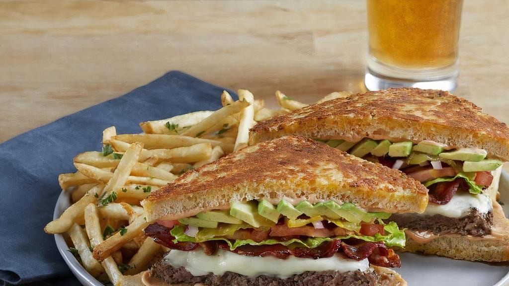 Quarter Burger · 100% USDA premium beef patty, crisp bacon, swiss cheese, avocado, lettuce, tomato, red onion, pickles and thousand island dressing on grilled garlic-parmesan sourdough bread. (1280 Cal)