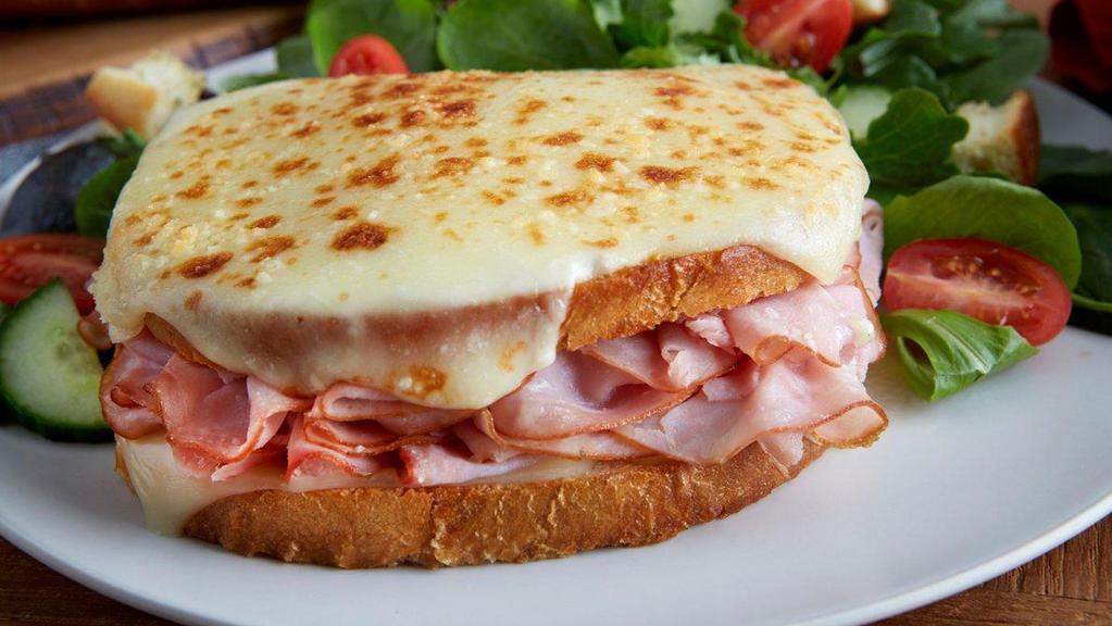 Croque Monsieur · Smoked ham and swiss cheese served warm on toasted sourdough topped with mornay sauce and melted parmesan. (840 cal) .
