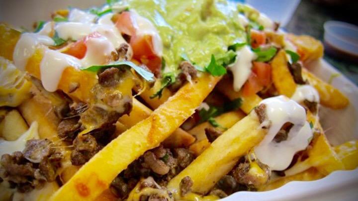 Nacho Fries · Choice of meat, white, or yellow cheese sauce, salsa ranchera, sour cream, guacamole and jalapeños.