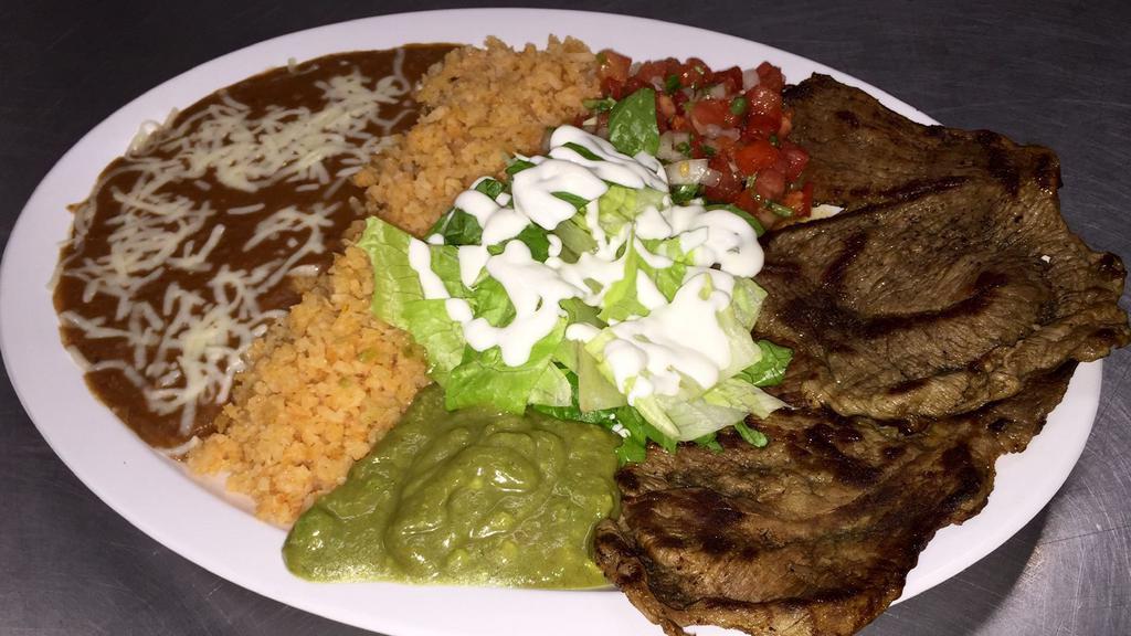 Plate · Choice of meat, beans, rice, guacamole, salsa ranchera, sour cream, lettuce, with four corn or flour tortillas.