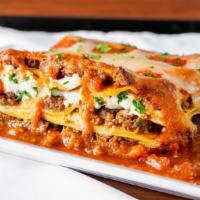 MEAT LAZAGNE · Layered pasta with hearty meat sauce, blend of cheeses, and savory ground beef.
