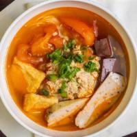 Bun Rieu · Crab & Shrimp Noodle Soup with  fried tofu, ham and pork blood.