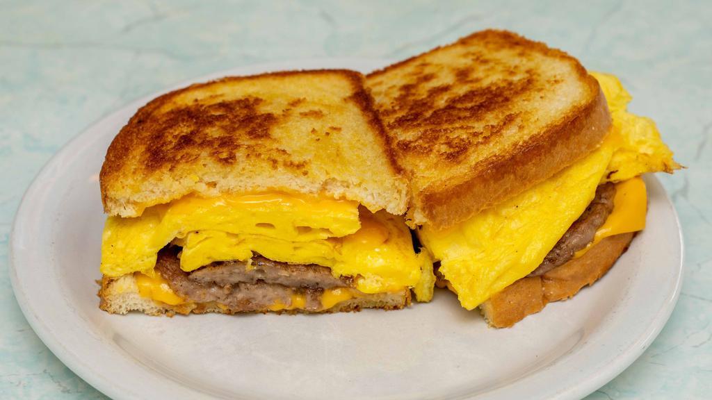 Breakfast Sandwich · Two eggs scramble, bacon or sausage and cheese (hash browns not included),