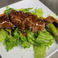 Asparagus Beef · Asparagus wrapped in grilled beef, with teriyaki sauce.