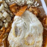 Chilaquiles · Fried tortilla chips, with green sauce, cheese, fresh onion, sour cream, nice and bean with ...
