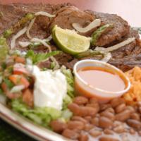 Steak Dinner Plate · Top Steak served with Grilled onions, guacamole, sour cream, pico gallo, Rice, Beans and Tor...