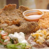 Milaneza · Breaded deep-fried Steak served with Rice, Beans, Guacamole, Sour Cream, Pico de Gallo and T...