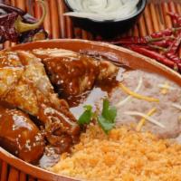 Chicken Mole · Chicken topped in our Home Made Mole Sauce served with Rice & Beans and Tortillas.