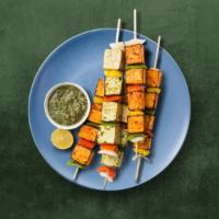 Cottage Cheese Tikka · Homemade cottage cheese cubes marinated in yogurt and spices cooked in clay oven with bell p...