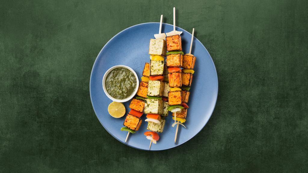 Cottage Cheese Tikka · Homemade cottage cheese cubes marinated in yogurt and spices cooked in clay oven with bell peppers and onion.