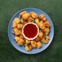 Crisp Veggie Fritters · Assorted veggies finely chopped, dipped in a spicy batter, and fried golden and crispy. Serv...