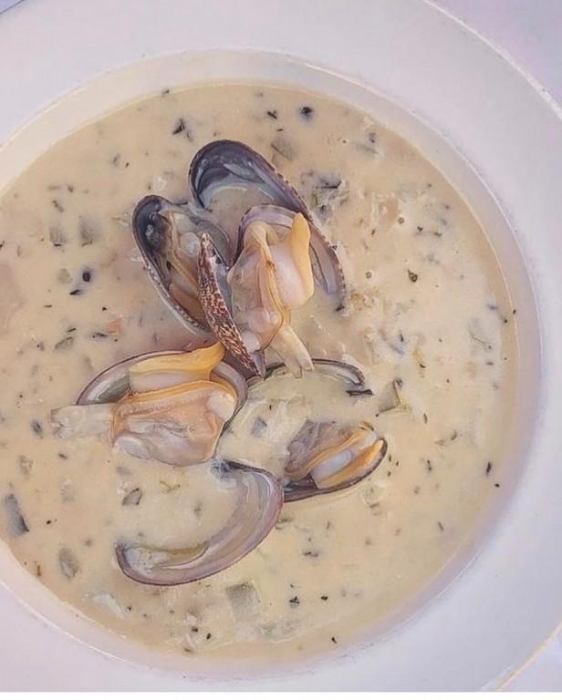 New England Clam Chowder · Baby manila clams, Yukon gold potatoes, celery, onion with a hint of bacon in a white wine cream broth sauce